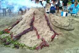 Smoking Volcano sand sculpture with red ti leaf lava